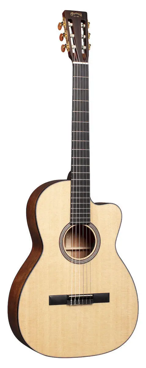 The Martin 000C12-16E crossover guitar standing against a white backdrop